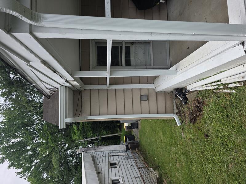 White downspout installed on side porch